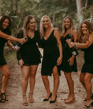 bachelorette party in Indialantic Florida mobile tanning five women in black dresses champagne black high heels bridesmaids