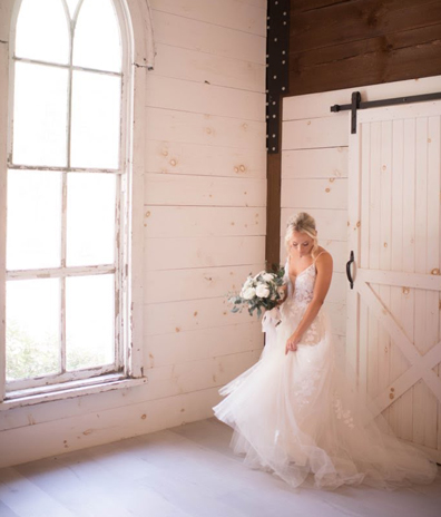 barn photoshoot white rose bouquet white wedding dress ceremony airbrush spray tan bridal party West Melbourne Beach Florida