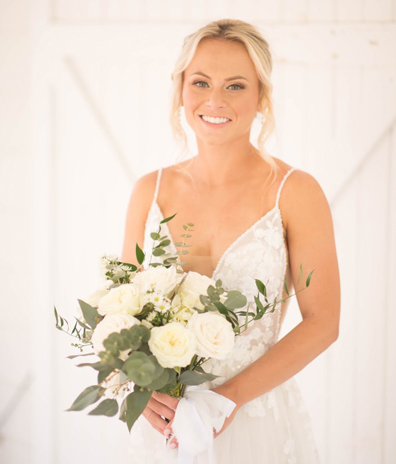 white rose flowers bouquet bride white teeth smile woman bride tanned skin airbrush spray tan in Port Canaveral Florida