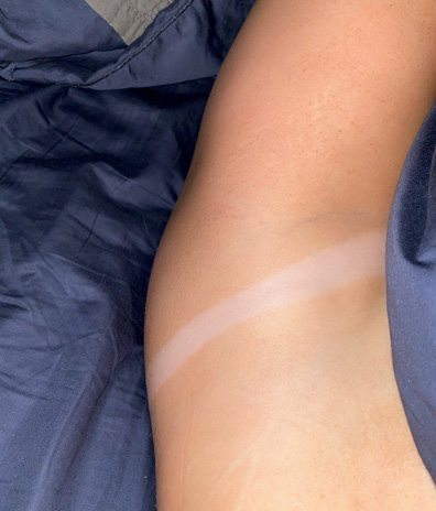 Palm Bay Florida spray tan service bikini tan line woman female purple bed sheets navy blue bed